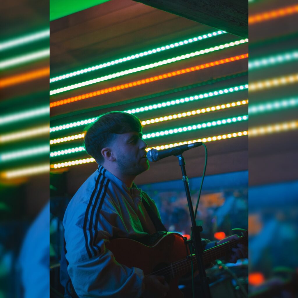 Tom Collins on guitar and mic